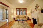 living room with sofas a glass table and carpet near fireplace mantel