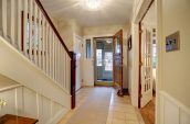 home foyer with staircase and front door