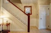 empty white painted stairs with side table and lampshade