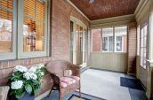 brown wicker armchair beside home front door