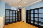 brown wooden shelf in room with blue walls