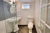small bathroom with glass panelled door and stand up shower