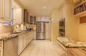 empty kitchen area with light yellow painted wall