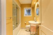 pink hand towel on rack beside sink