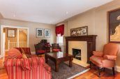 rectangular brown wooden coffee table beside fireplace