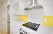 stove in kitchen with white cabinets