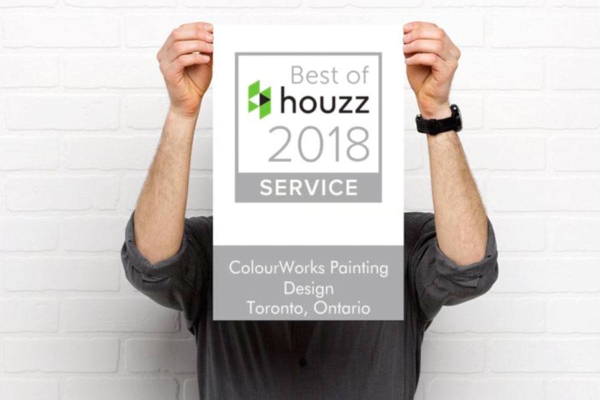 person holding best of houzz 2018 service poster