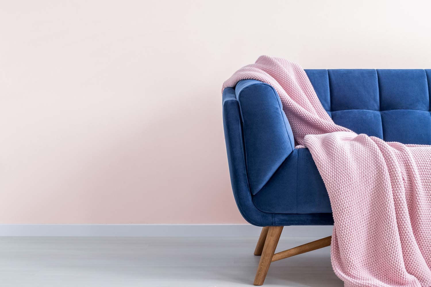 pink blanket on blue sofa
