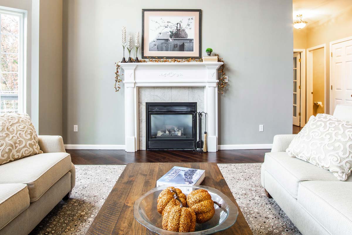 bowl of squash on wooden coffee table in between couches