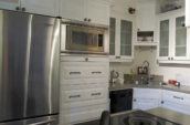 kitchen with white cabinets and stainless steel refrigerator