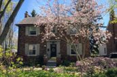 brown stone wall 2-storey house with chimney