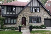 grey stone house exterior from front lawn