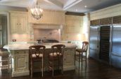 white kitchen with island and chairs