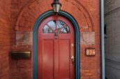 brown wooden door beside 834 house number