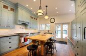 rectangular wooden table with chairs between cupboards