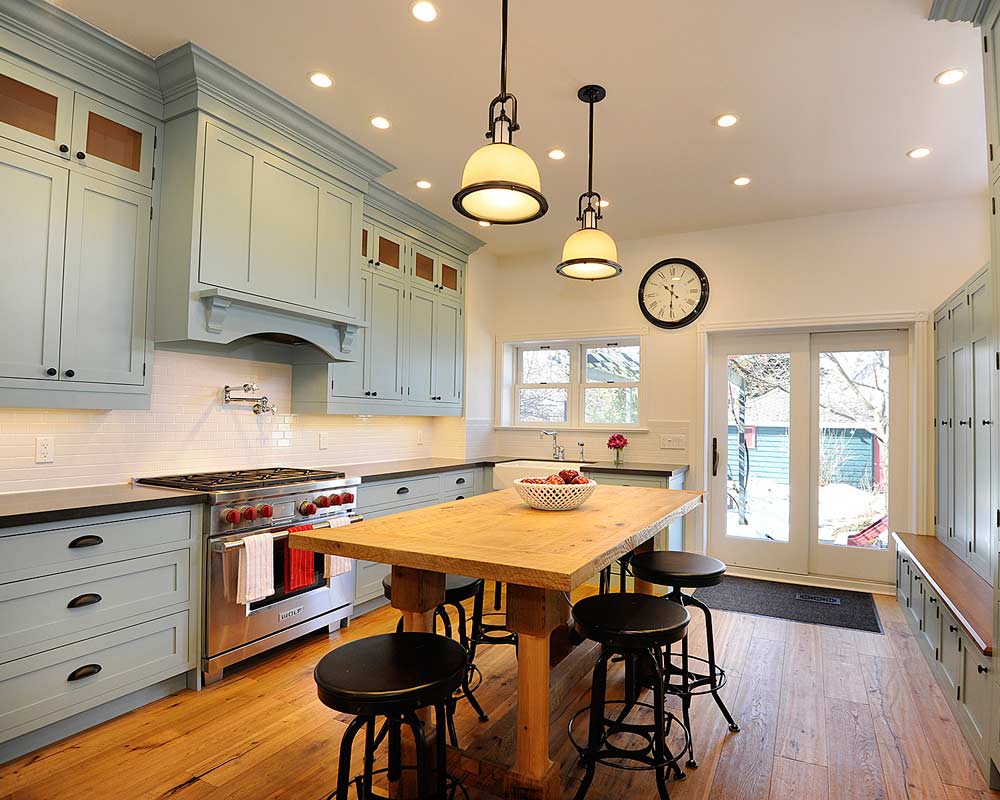 kitchen with turned on lights in kitchen with blue cabinetry