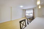 rectangular white kitchen island with four wooden chairs