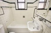 bathroom with white tiling sink bathtub and toilet