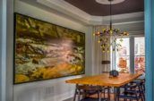 dining room with hardwood floors large painting on the wall wooden dining set and painted ceiling